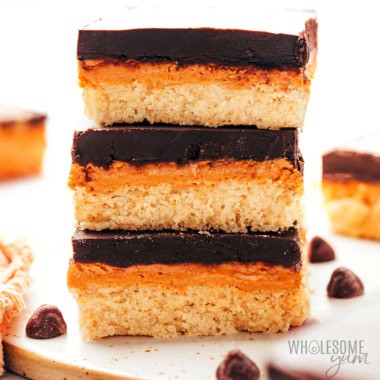 Chocolate peanut butter bars in a stack.