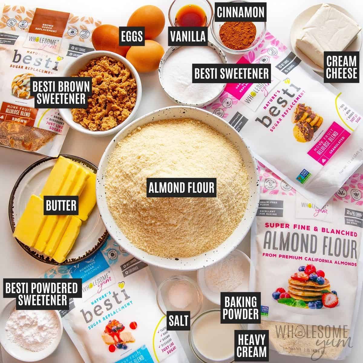 Labeled recipe ingredients: Cream cheese, powdered Besti, vanilla extract, unsalted butter, granulated Besti, eggs, heavy cream, almond flour, baking powder, Besti Brown, cinnamon, and sea salt.