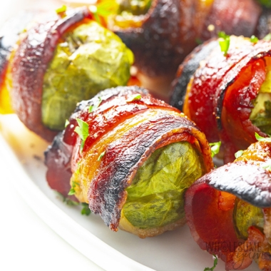 Brussels sprouts wrapped with bacon on a serving dish