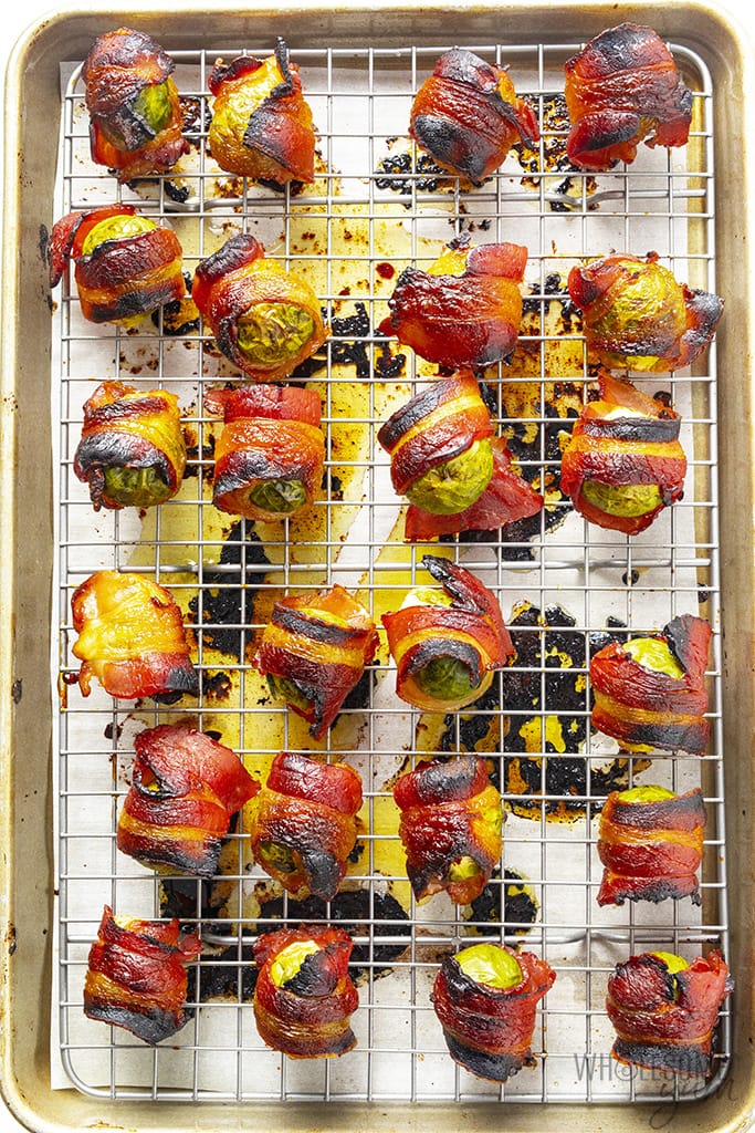 Roasted brussels sprouts with bacon on a sheet pan with a rack
