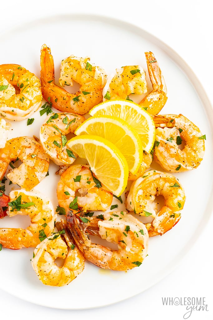 Low carb shrimp on a plate with lemon and parsley
