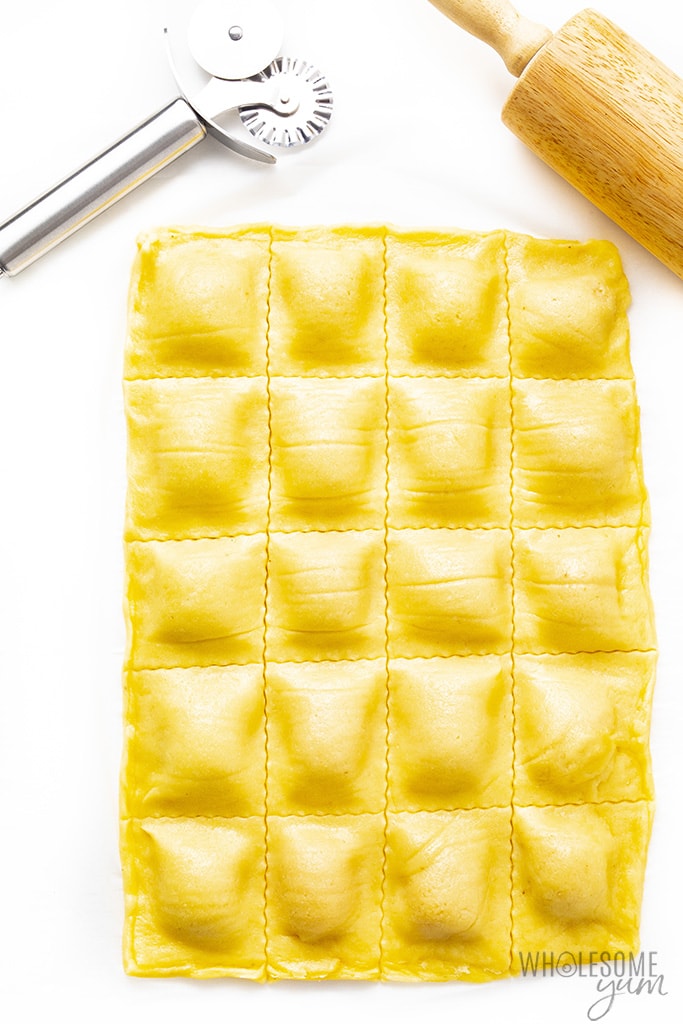 Low carb ravioli dough filled with butternut squash and cut with a ravioli wheel