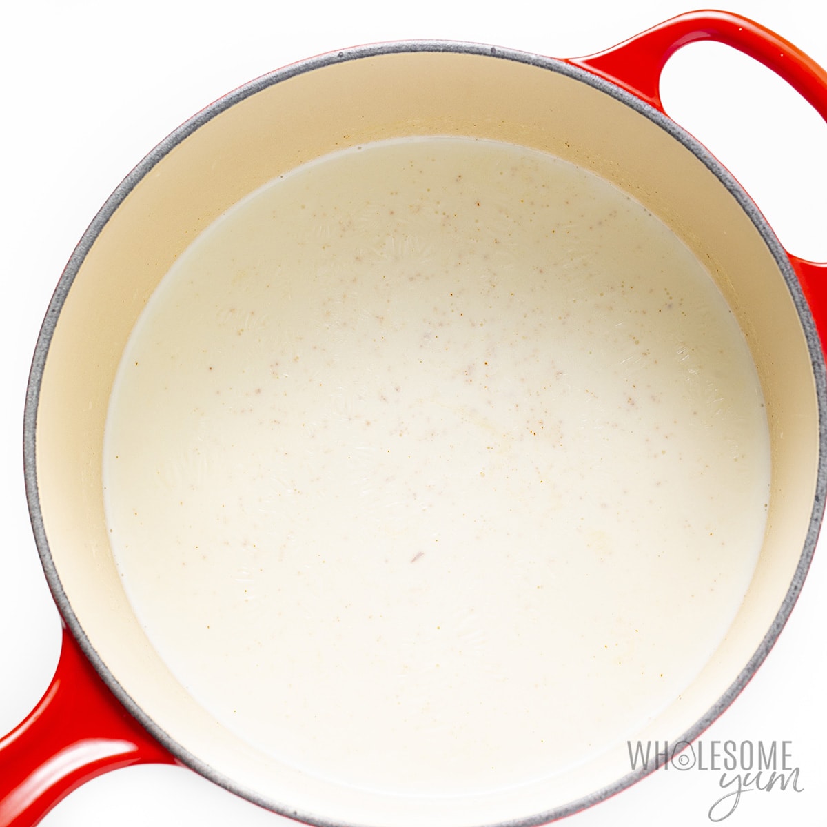 Cream and almond milk in a saucepan.