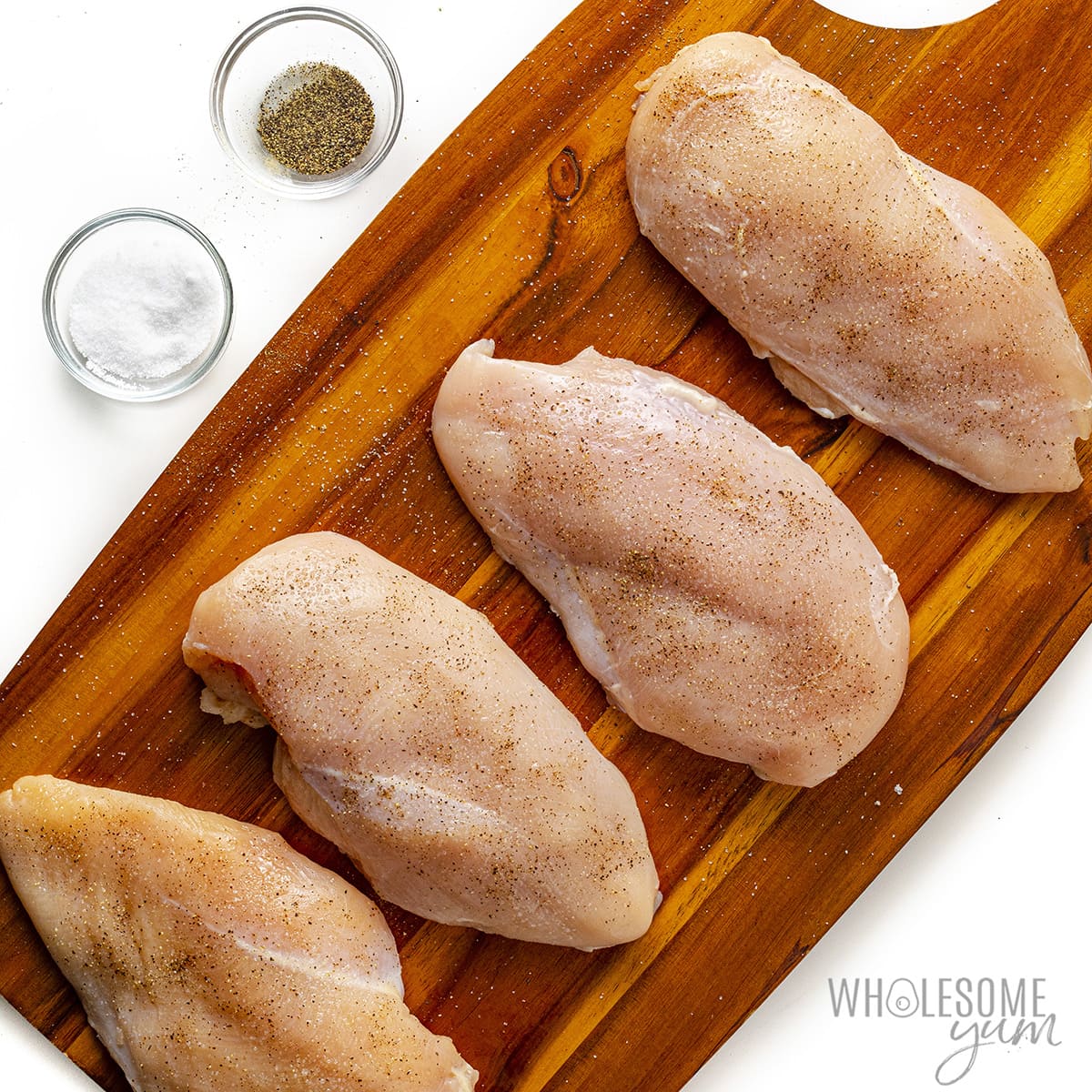 Chicken patted dry and seasoned with salt and pepper.