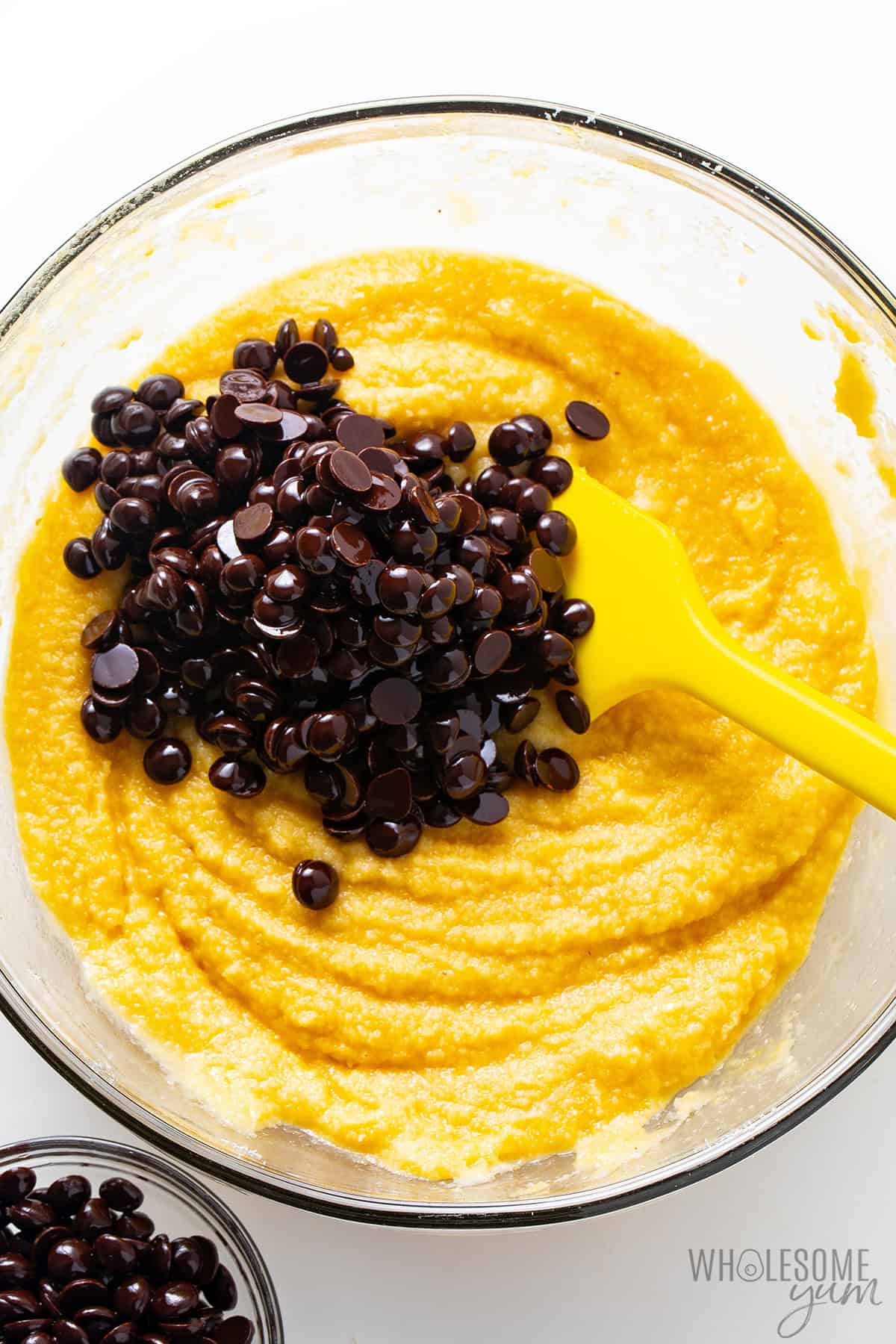 Folding chocolate chips into the muffin batter.