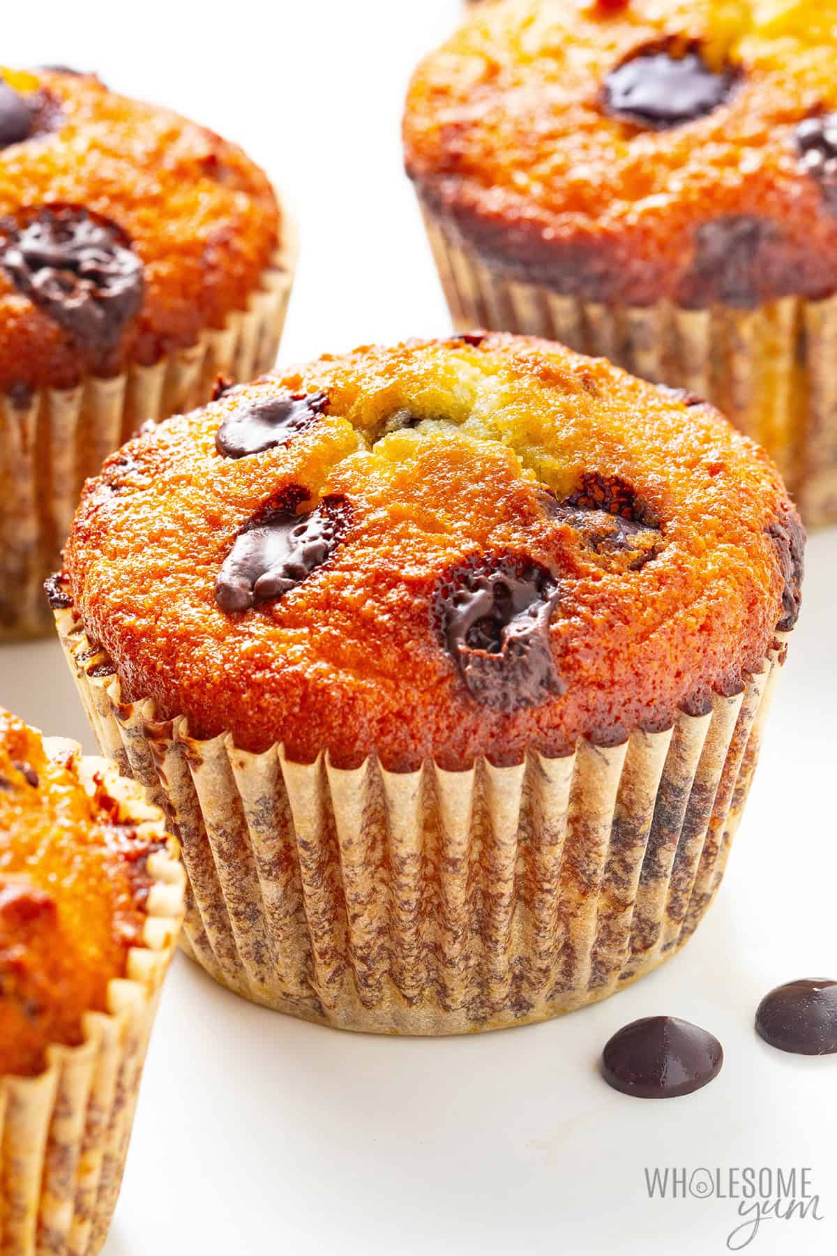 Moist, buttery, bakery-style almond flour chocolate chip muffins on the counter.