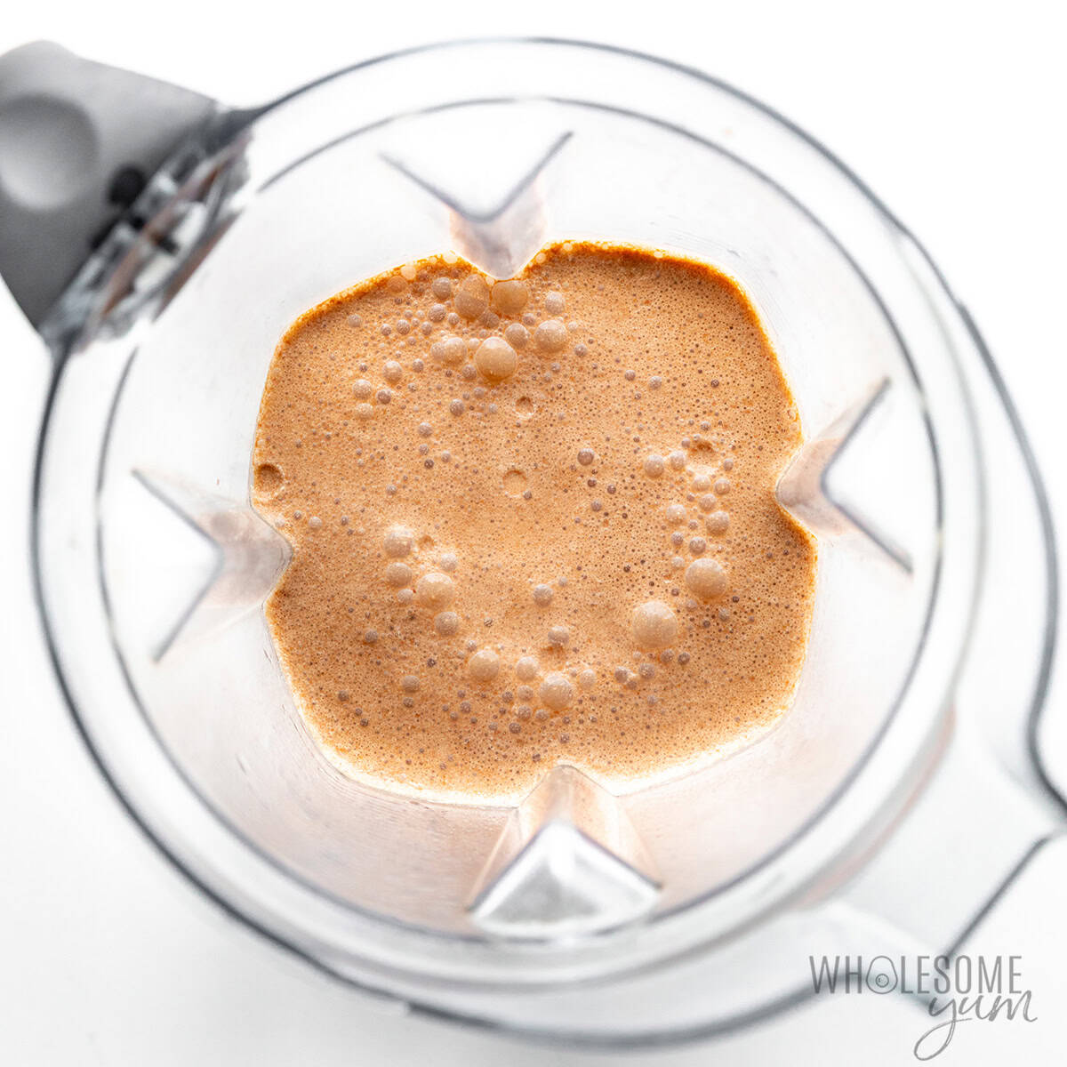 Frothy keto chocolate milk blended in a blender.