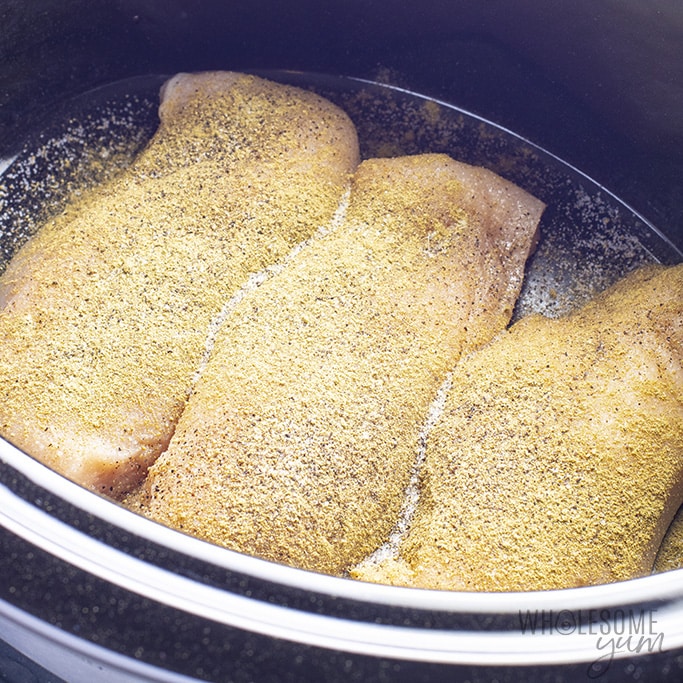 Chicken breast and seasoning in slow cooker