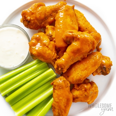 Buffalo chicken wings on a plate with celery and blue cheese