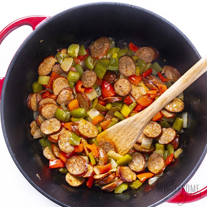 Sausage in dutch oven with peppers onions and celery