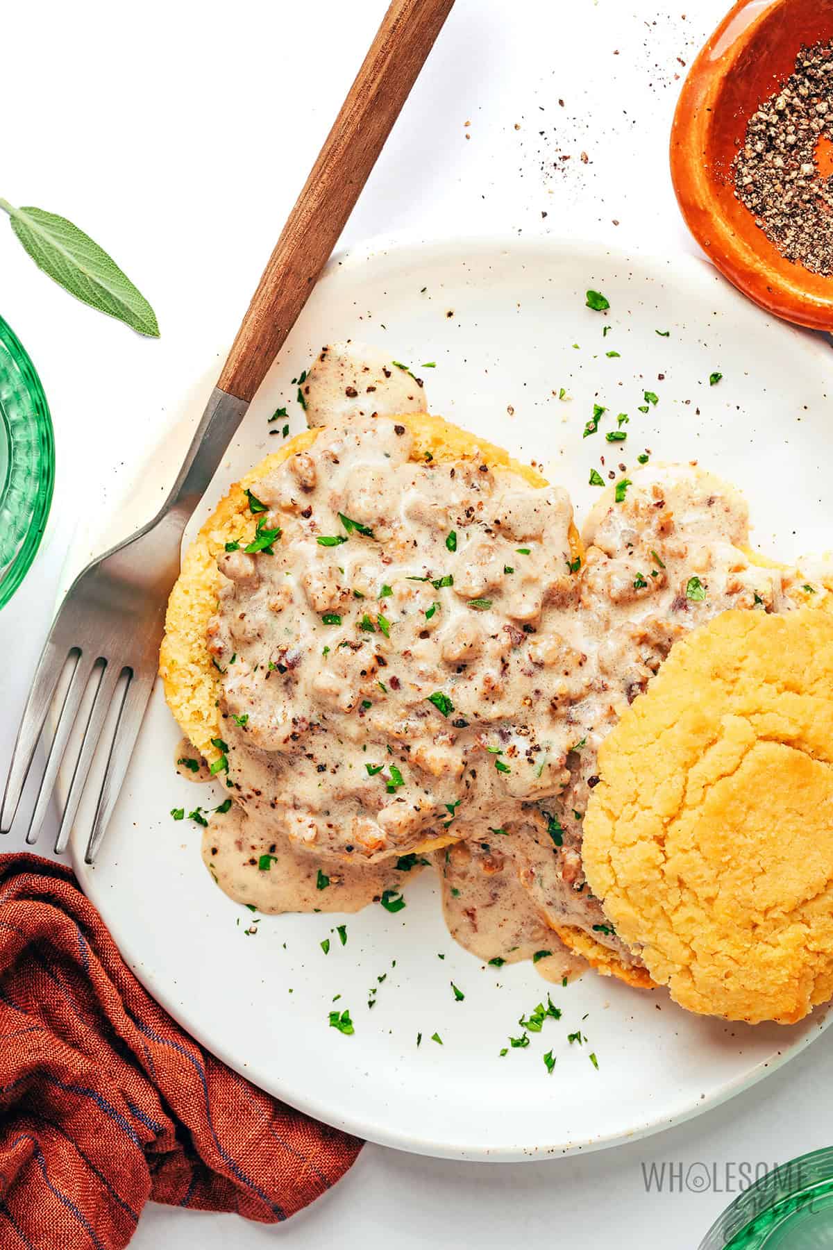 Homemade sausage gravy spooned over biscuits and garnished with parsley.