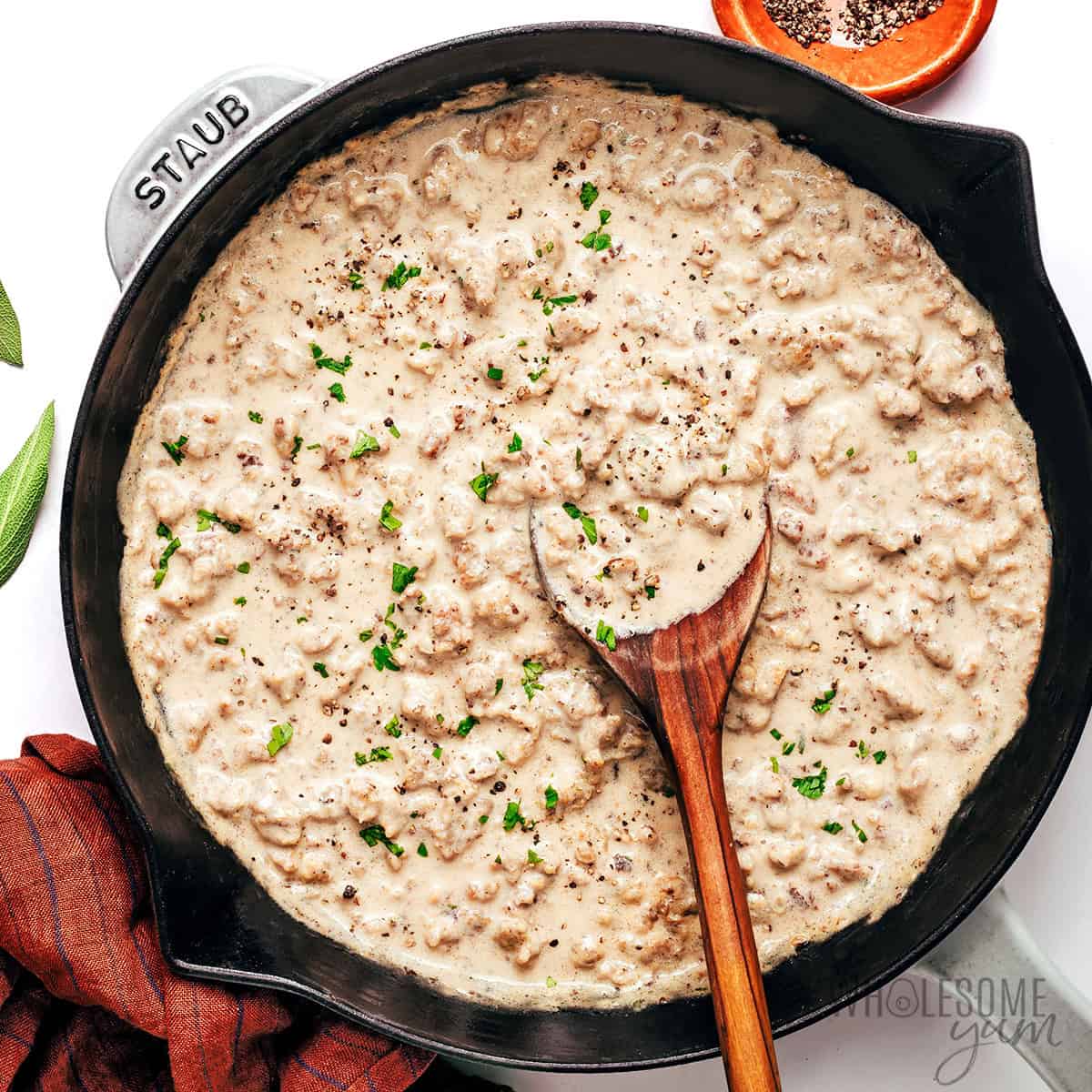 Finished sausage gravy recipe in the skillet with fresh parsley.