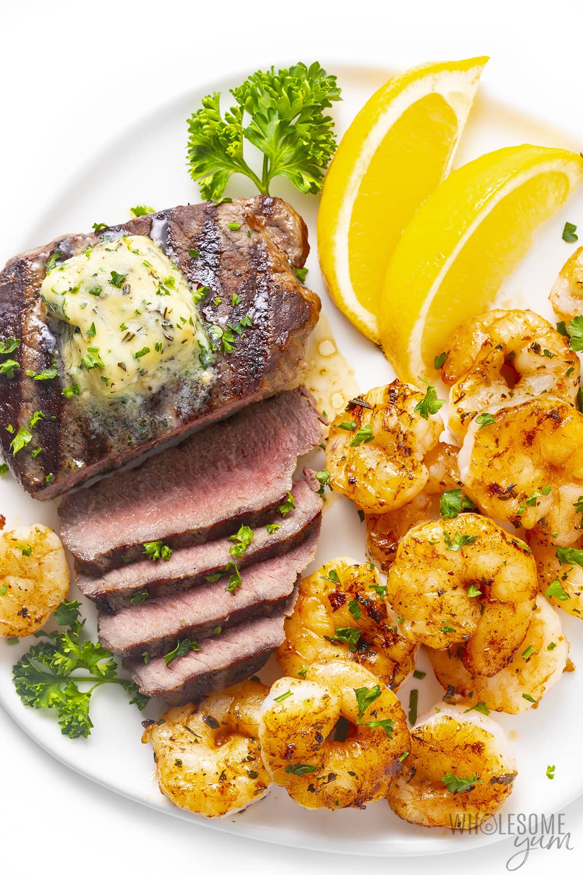 Surf and turf on a plate with the steak sliced.