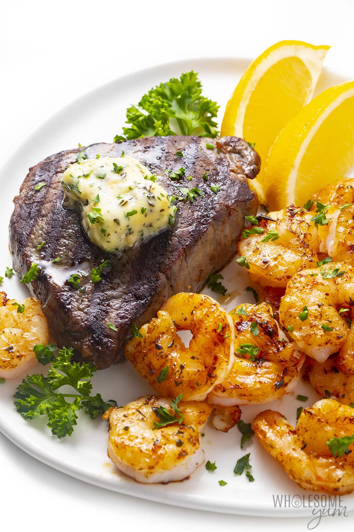 Surf and turf on a plate topped with garlic butter.