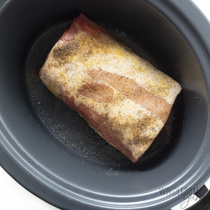 Pork loin roast in a slow cooker with salt and pepper