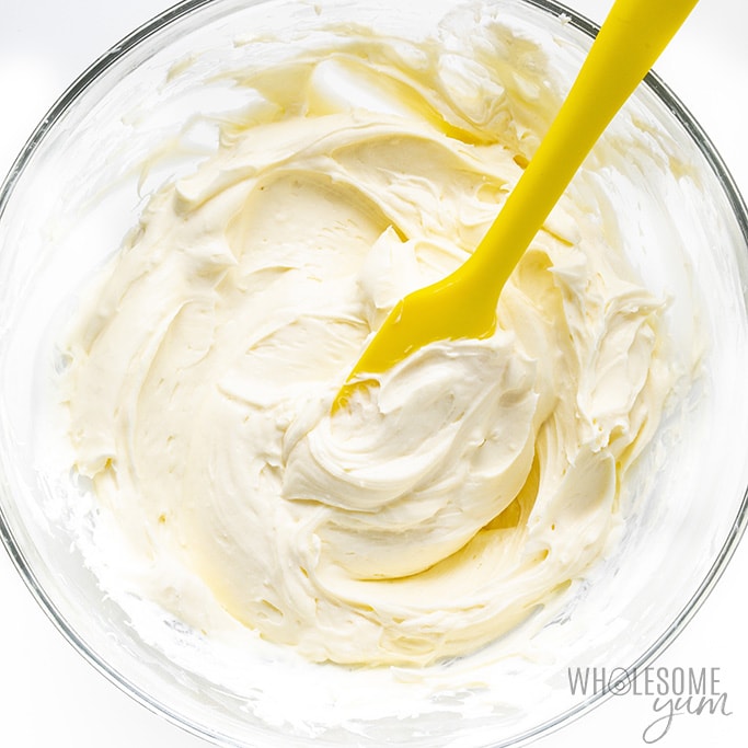 Cream cheese and whipped cream mixture for no bake cheesecake folded together in a glass bowl