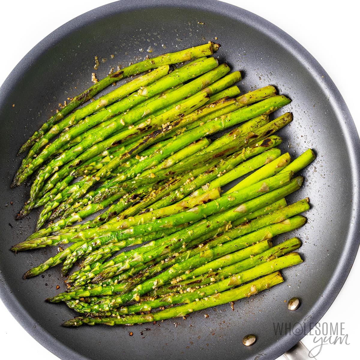 Sauteed asparagus in a skillet.