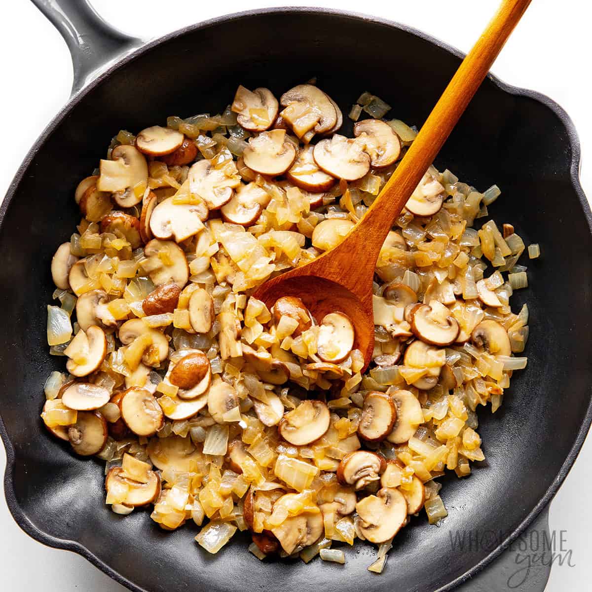 Sauteing mushrooms and onions in the skillet.