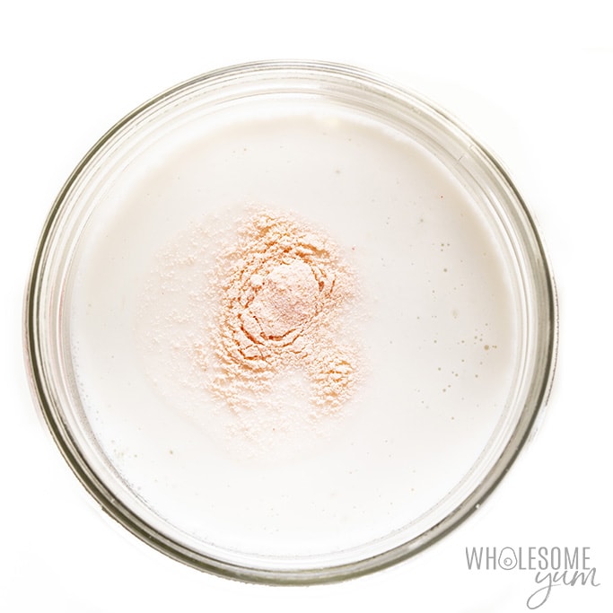 Coconut yogurt recipe in a glass jar with added probiotic powder