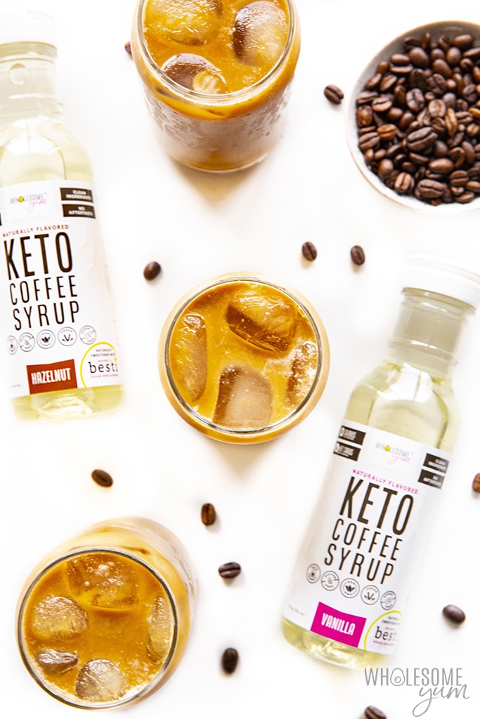 Keto iced coffee with bottles of keto coffee syrup.
