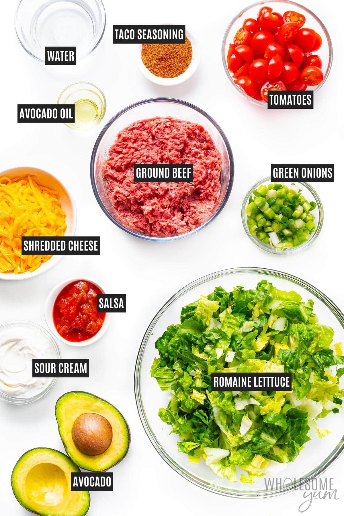 Taco salad ingredients in bowls.
