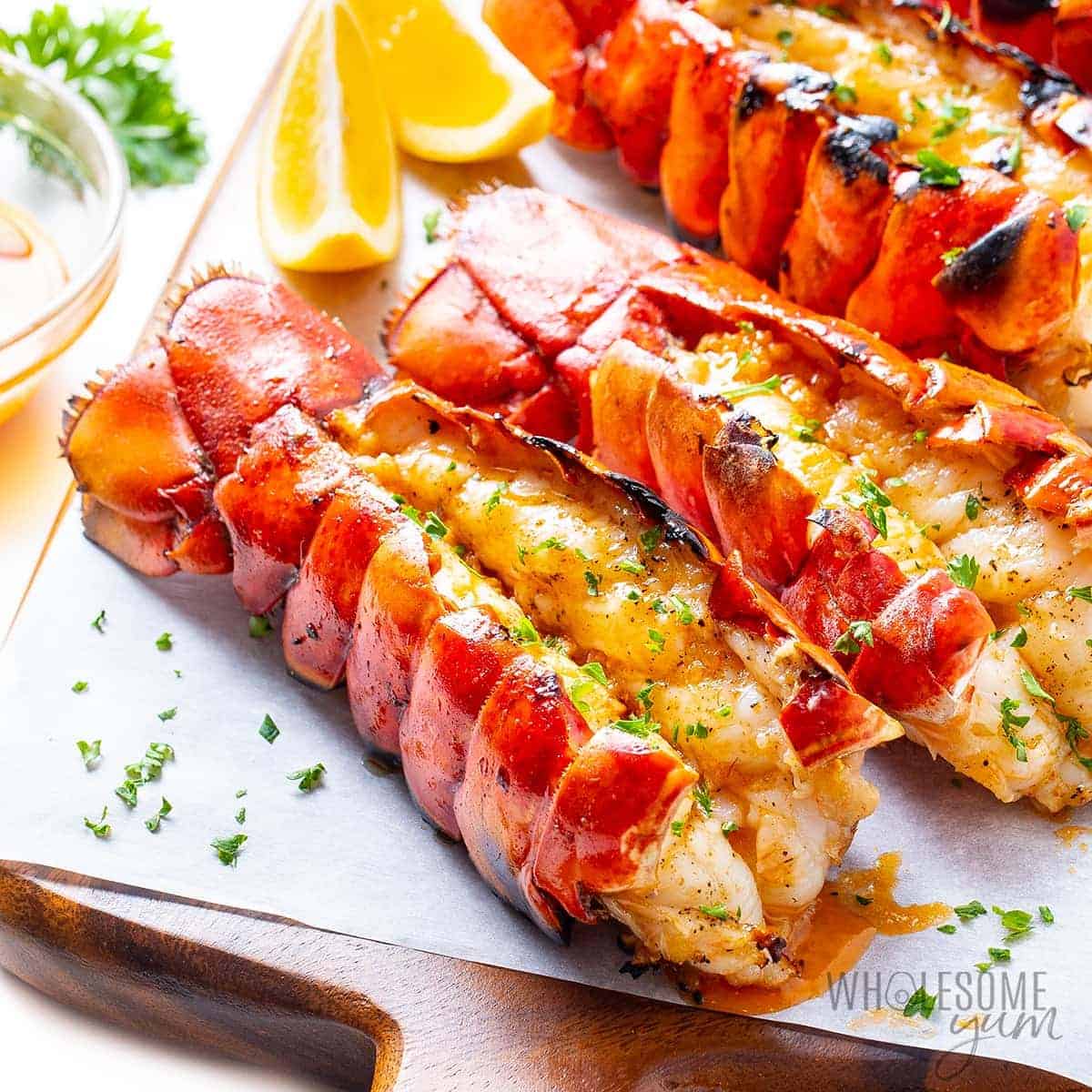 Grilled lobster tails on a cutting board