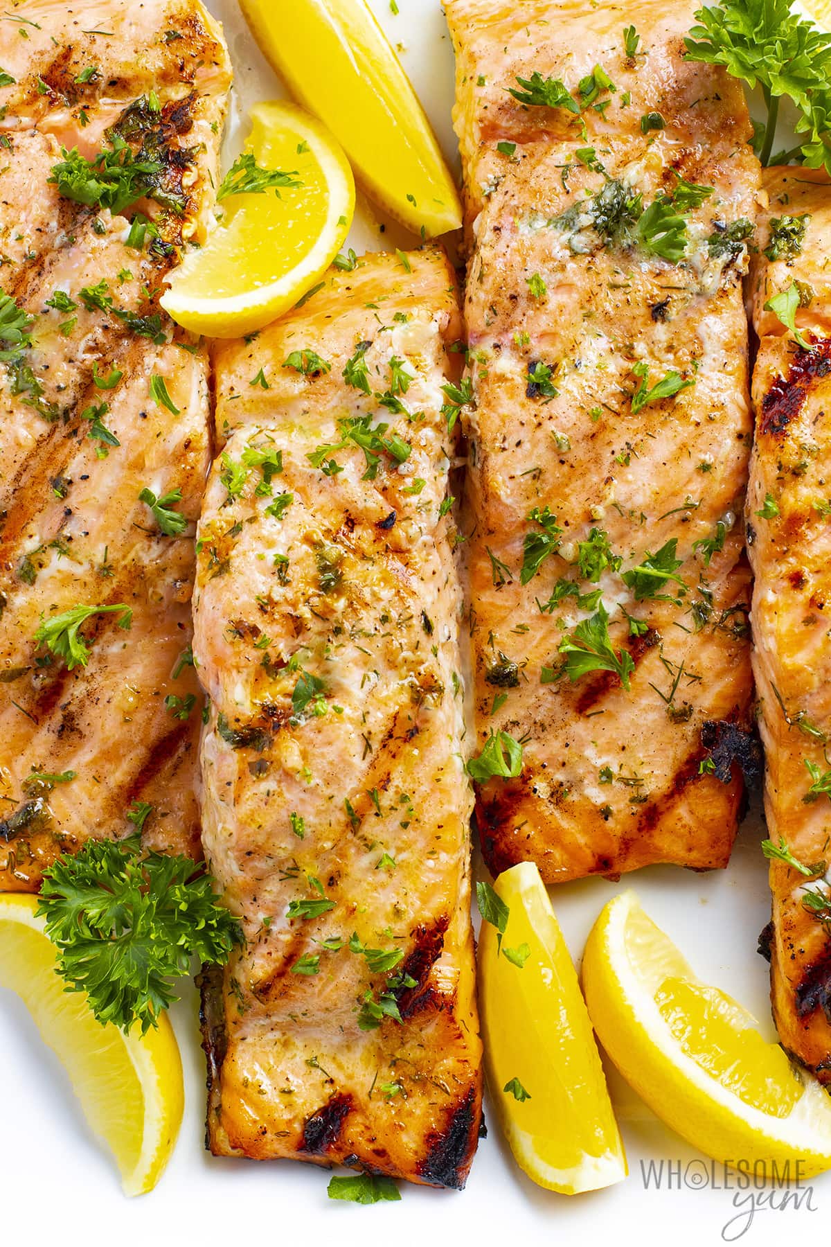 Grilled salmon with lemon slices.