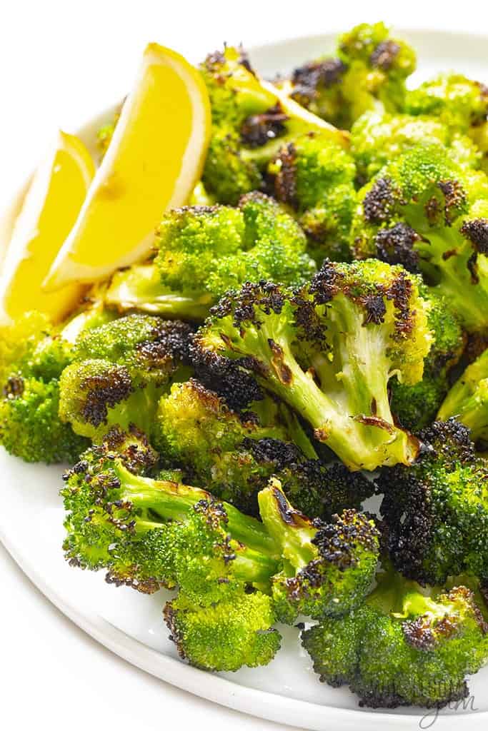 Grilled broccoli with lemon wedges.