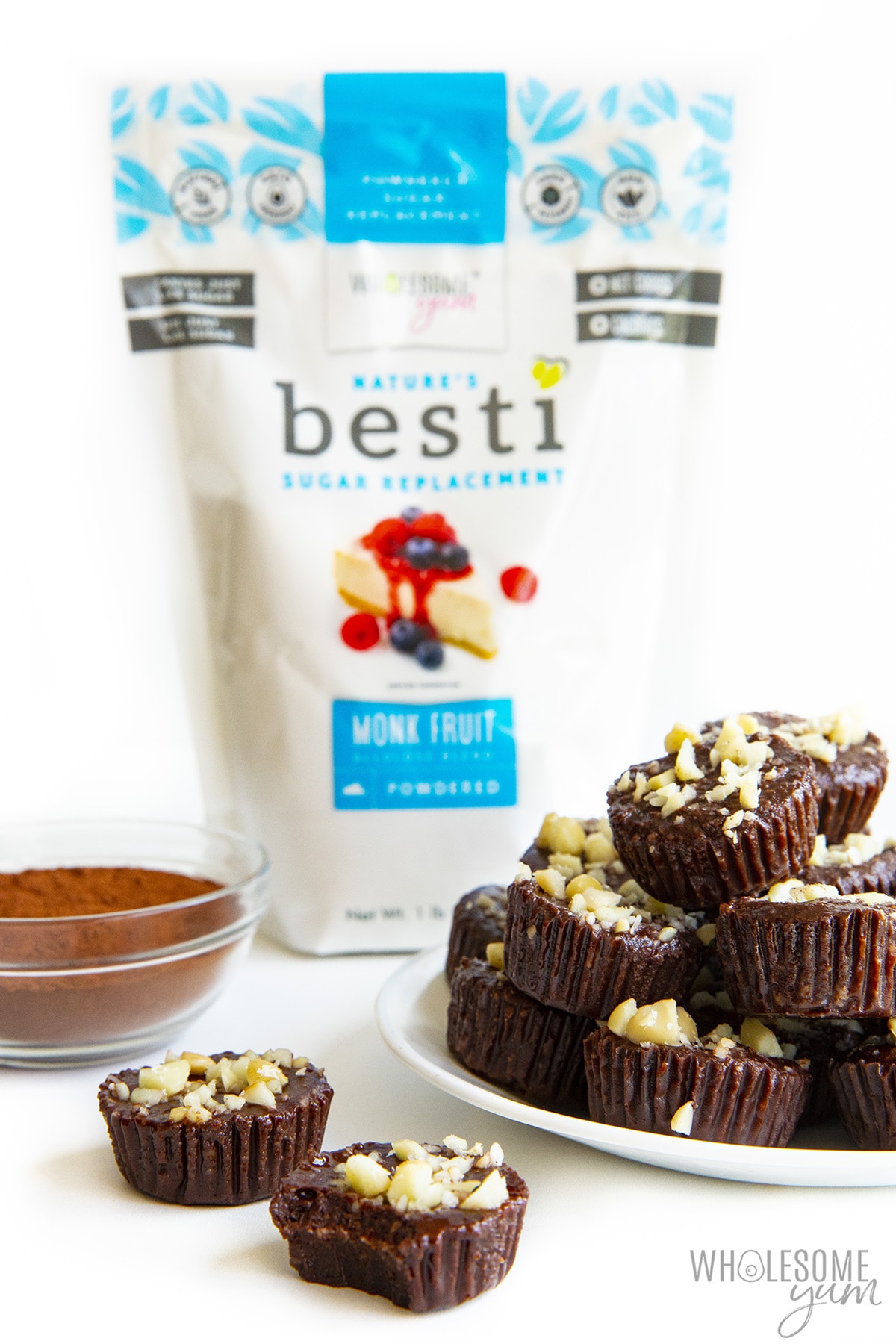 Chocolate fat bombs on a plate next to powdered Besti. 