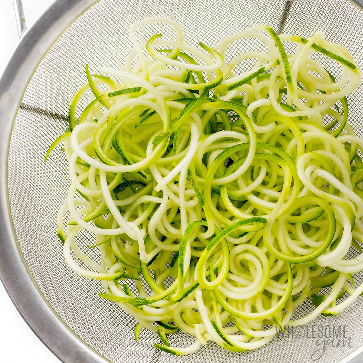 Draining zoodles in colander.
