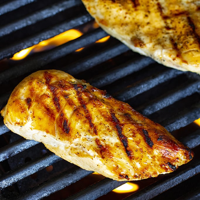 Chicken breast cooking on a grill