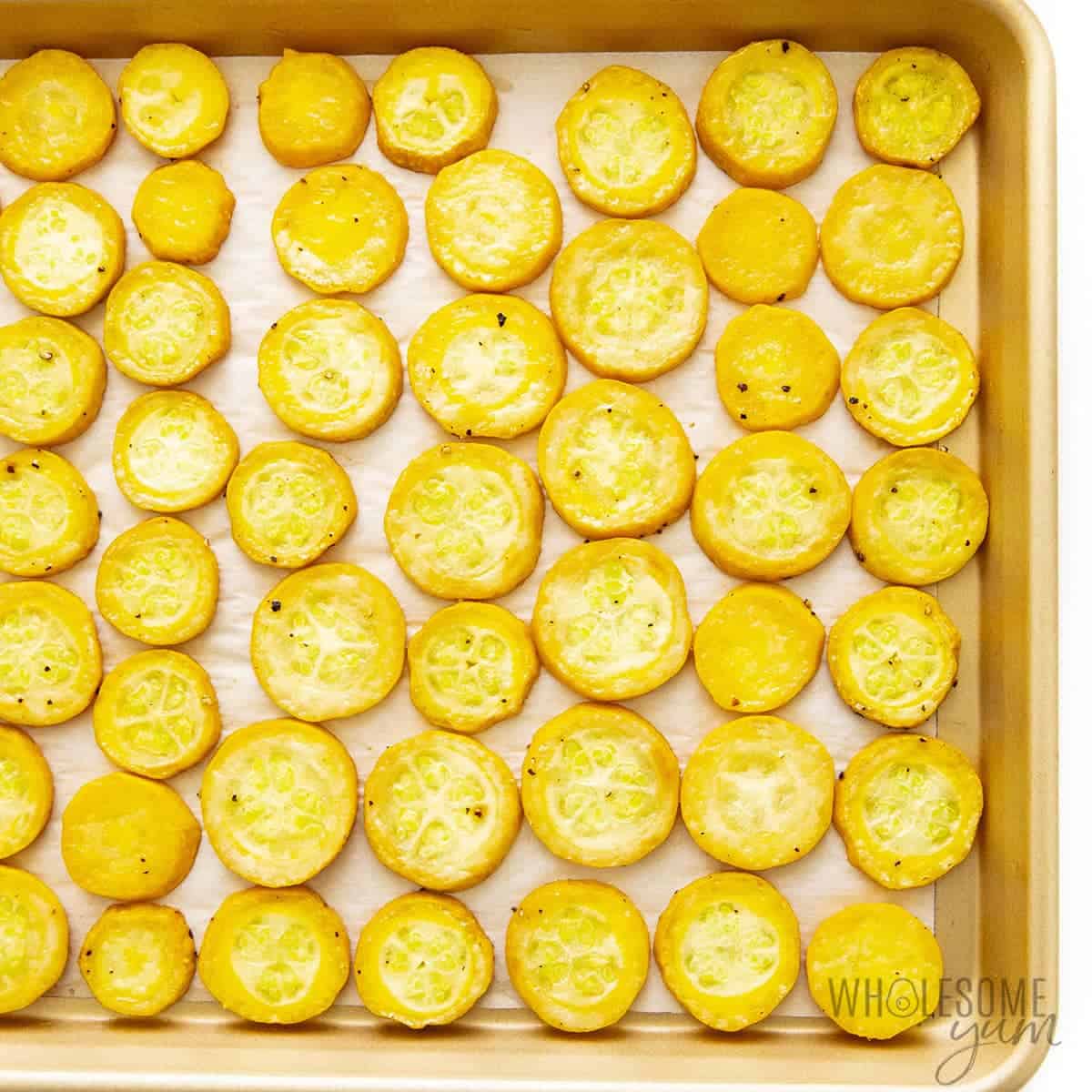 Roasted yellow squash on a sheet pan.