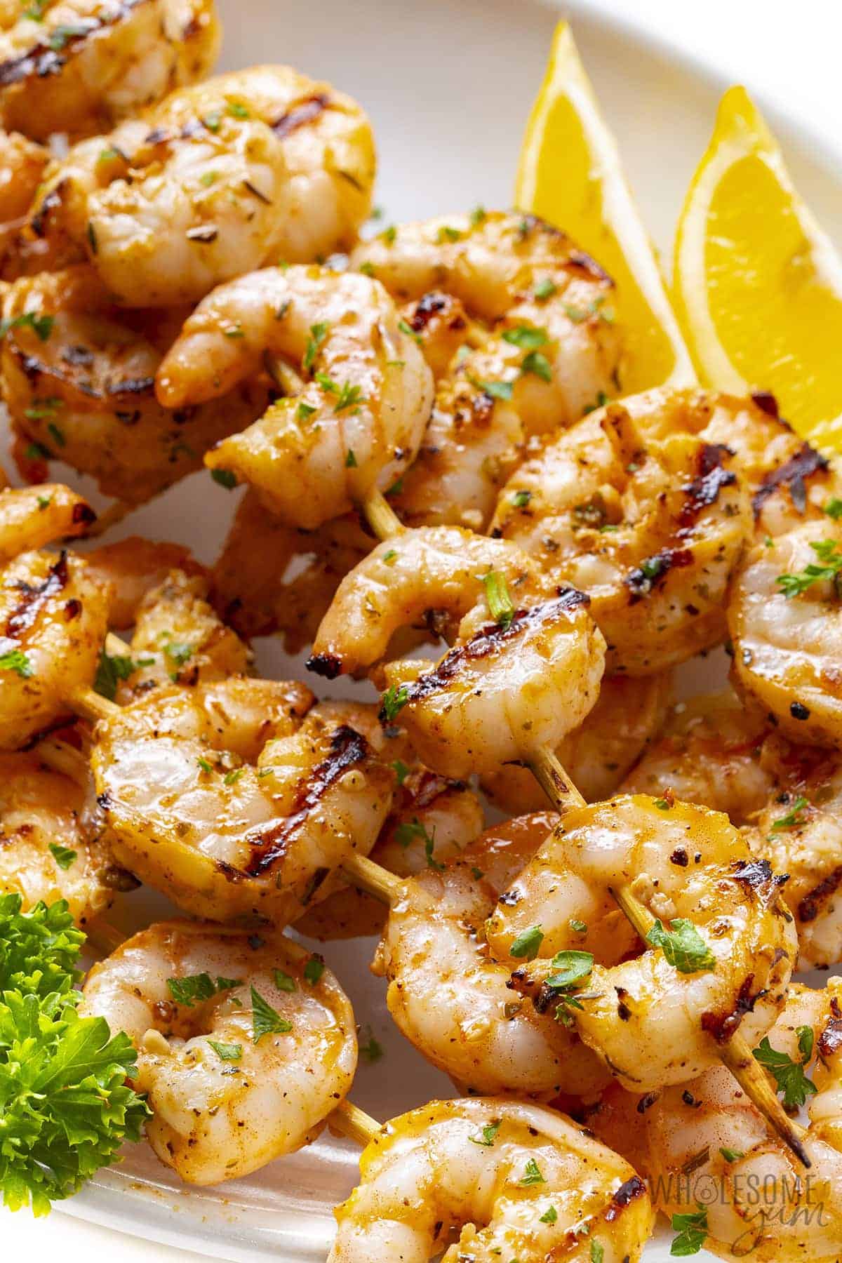 Close up of grilled shrimp skewers on a plate