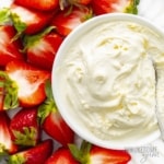 Homemade mascarpone cheese in a bowl with strawberries