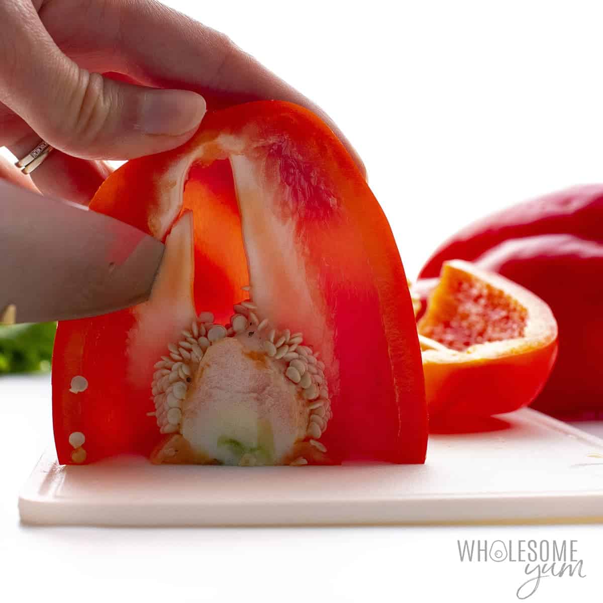 Knife cutting red pepper 