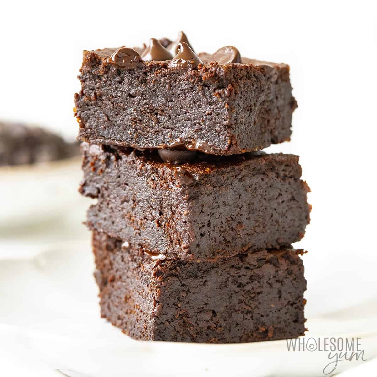 Stack of keto coconut flour brownies on a plate
