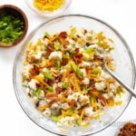 Loaded roasted cauliflower salad recipe in a bowl with garnishes