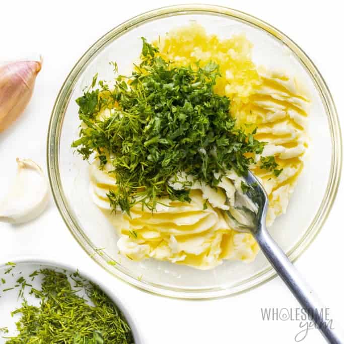 Fresh herbs in mashed butter.