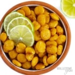 Lupini beans recipe in a bowl with sliced lime