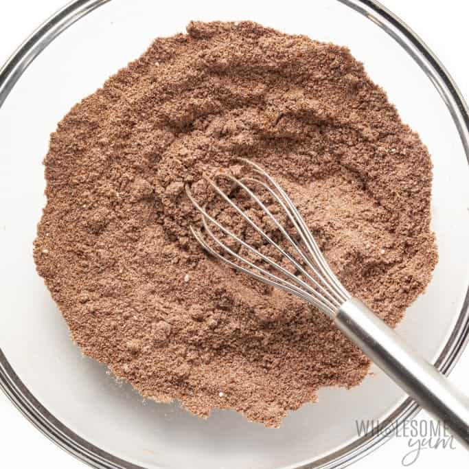 Dry ingredients for donuts in a bowl with whisk