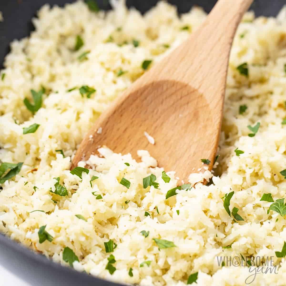Cauliflower rice close up with wooden spoon