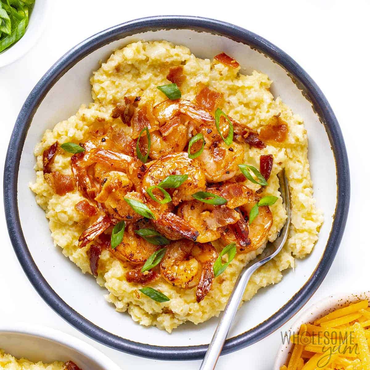 Cauliflower grits and shrimp in a bowl with spoon