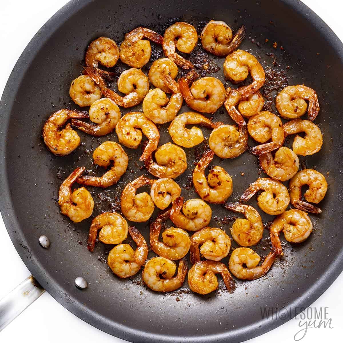 Cajun shrimp cooking in a skillet