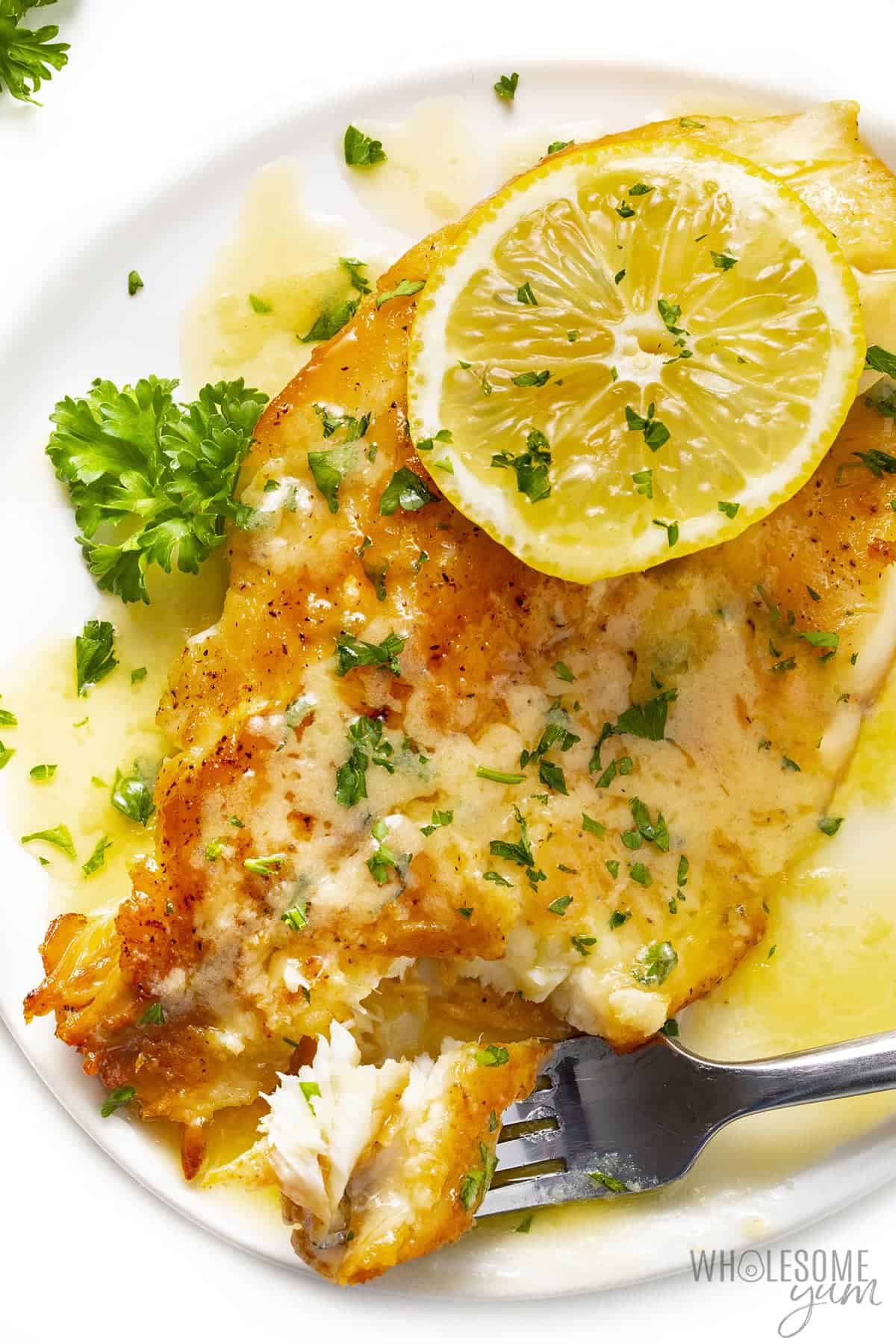 Pan seared tilapia with lemon butter sauce with fork