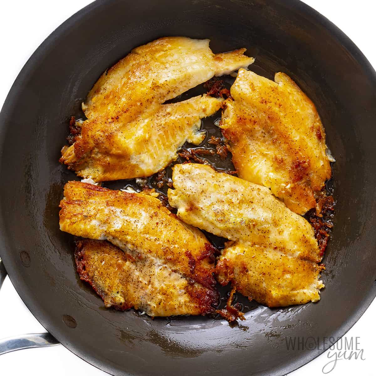 Fillets crisping in a pan.