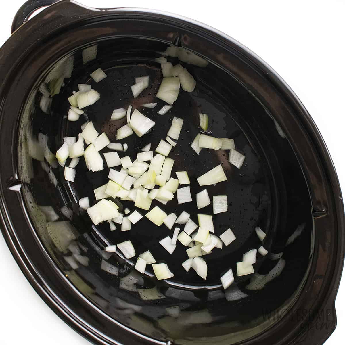 Diced onion in slow cooker.