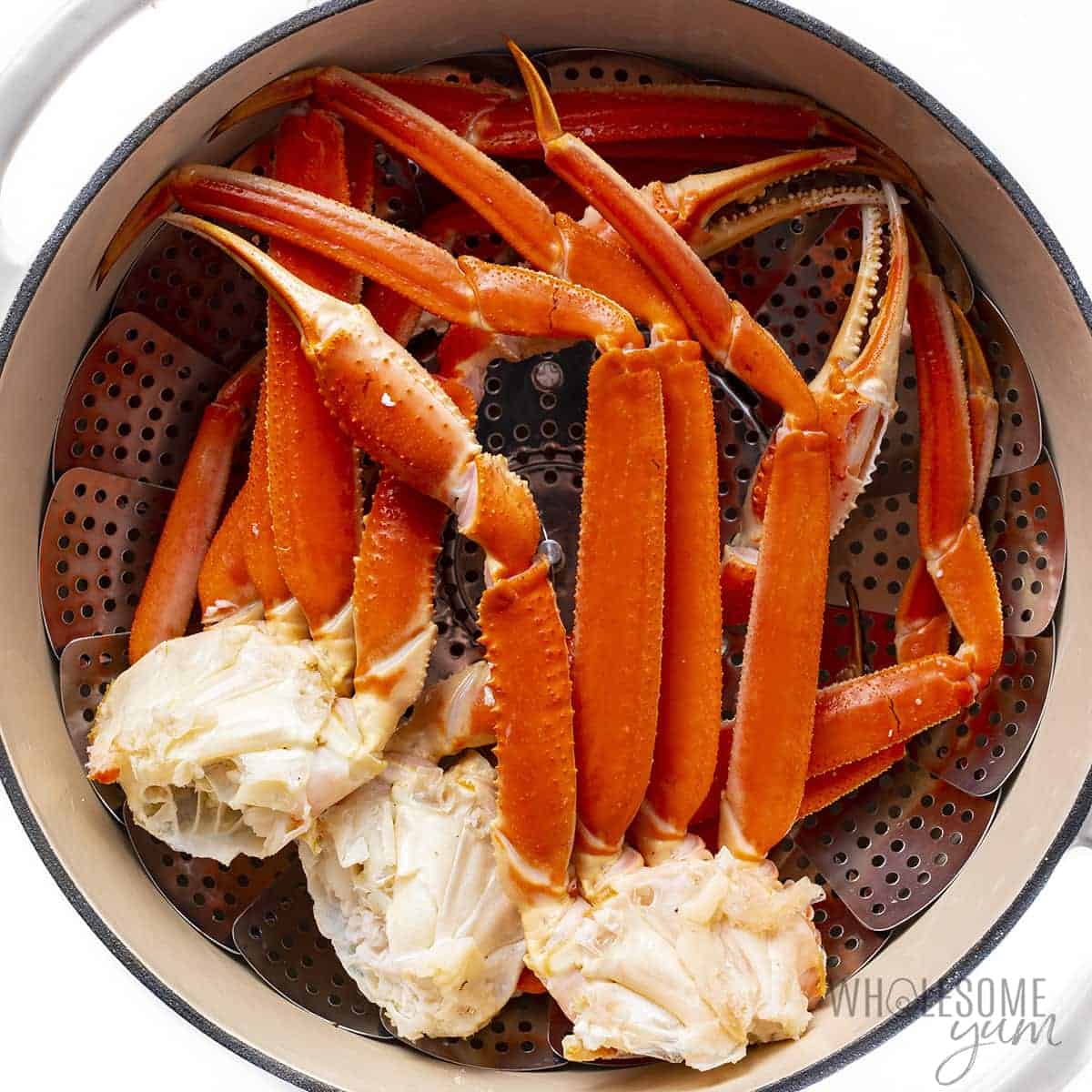 Crab legs in steamer basket.