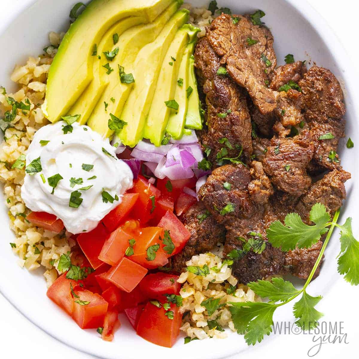Plated keto burrito bowl with garnishes