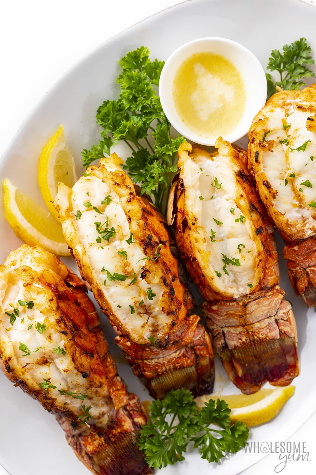 Lobster tails roasted in a dish.