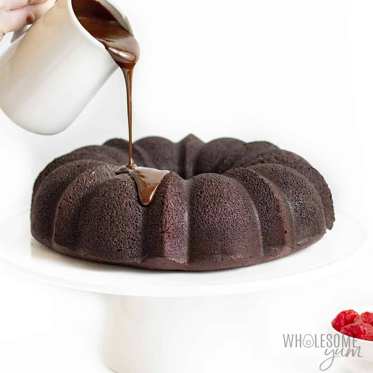 Chocolate icing for bundt cake pouring onto whole cake